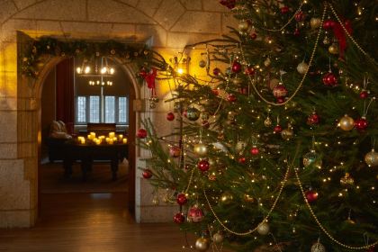 Entrance hall decorated for Christmas at Castle Drogo in Devon