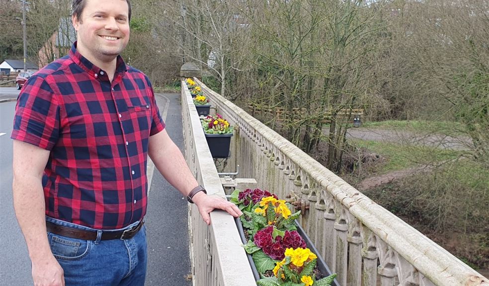 Man standing on a bridge in Ottery St Mary