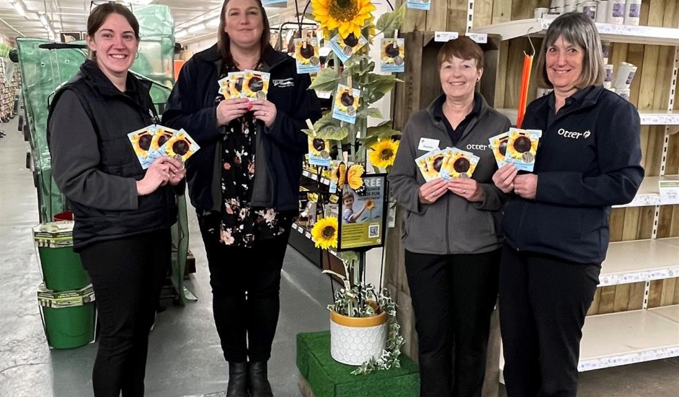 Group of people holding sunflower seed packets