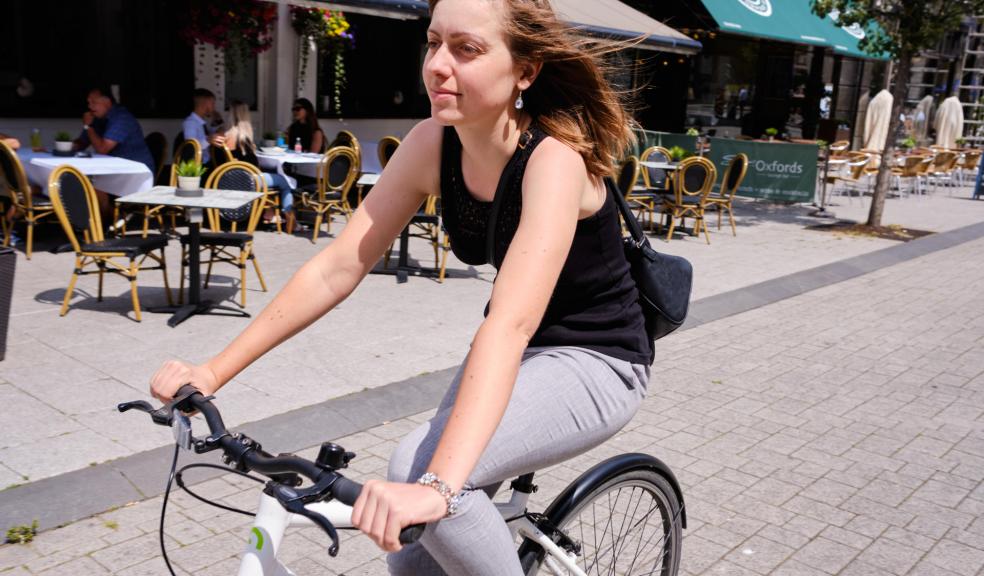 Woman cycling on high street that has been closed to motor traffic