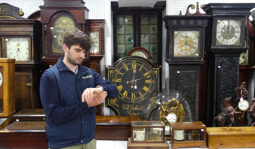 Auctioneer Barnaby Willis with some of the clocks Chilcotts Auctioneer Barnaby Willis with some of the clocks
