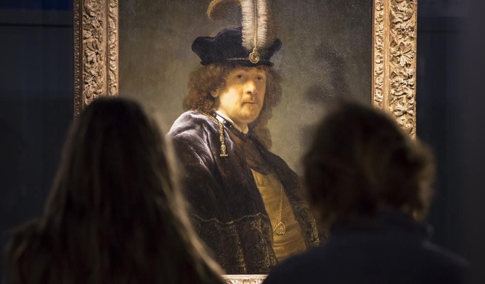 Visitors admiring the Rembrandt self-portrait. Credit: National Trust / Chris Lacey.