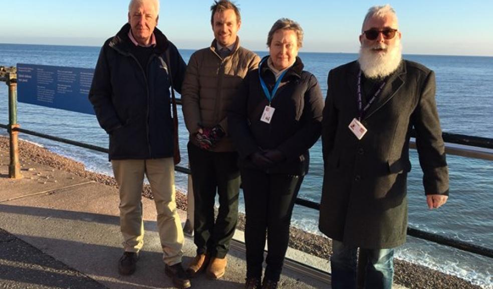 Left to right: Cllr Geoff Jung (portfolio holder for the environment), East Devon Engineering Projects Manager, ward members Cllrs Cathy Gardner and John Loudoun, standing next to the newly installed glass test splash panel, which will be trialled until the end of April. A splash defence is a way of stopping waves crashing on to the esplanade and flooding Sidmouth