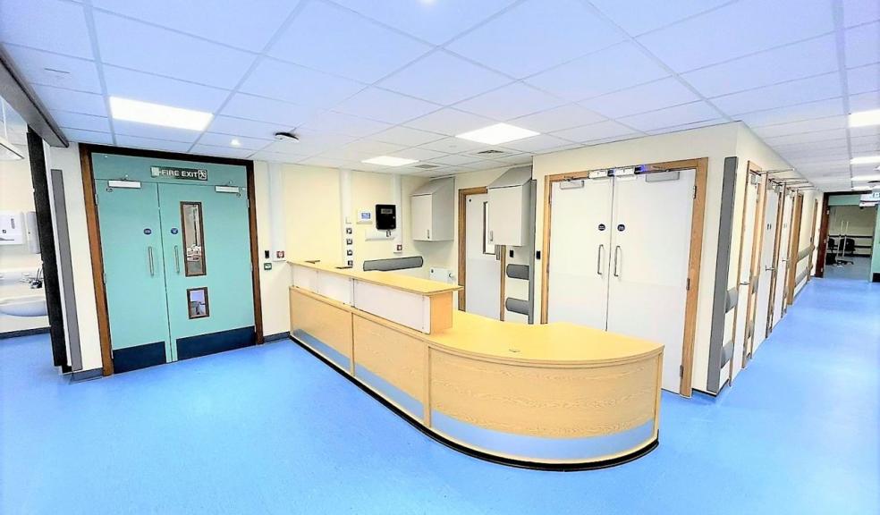 Hospital corridor with blue floor.  