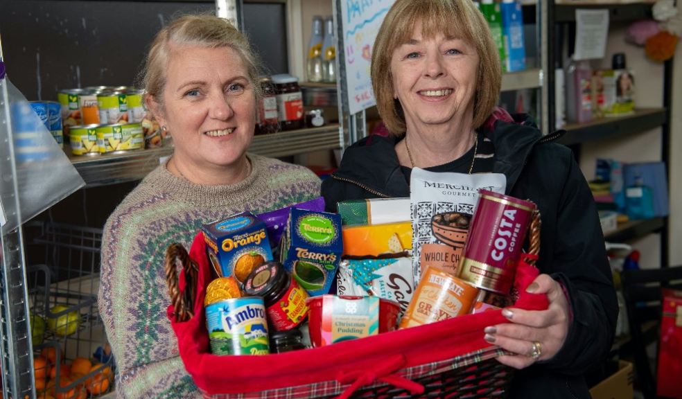 Volunteers Helen Jones, left, and Sue Corbett at The Willand Food Network preparing festive hampers for local families. The annual initiative has been supported by housebuilder Bellway, which is building new homes at Fox Mill Gardens in the village.
