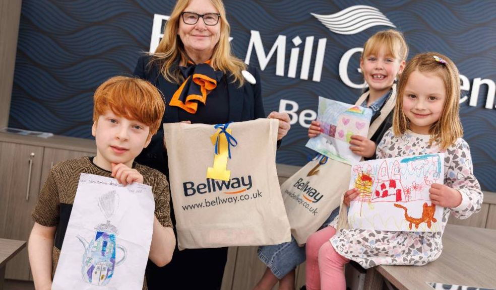 Photo caption: Bellway Sales Advisor Jill Moores with the Willand School pupils holding up their original artwork by the display board at Fox Mill Gardens in the village.