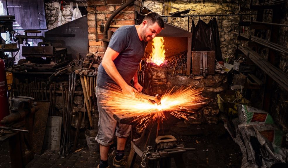Blacksmith sends sparks flying at the anvil at Branscombe. ©National Trust Images, Eric McDonald.