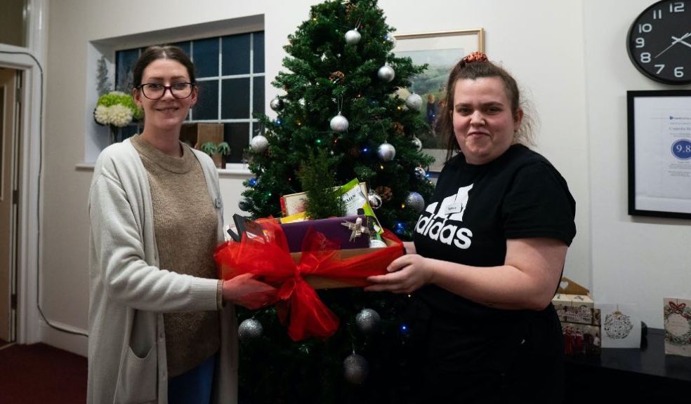 Bovey Castle's Miriam Youngson and Reanne Salter donating to Coppelia House care home.