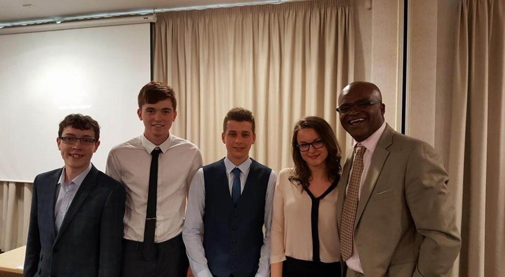 Photo caption. Left to right: Brandon Howarth, Cameron Mealy, Hayden Minhinick and Justyna Nowak with Kris Akabusi.