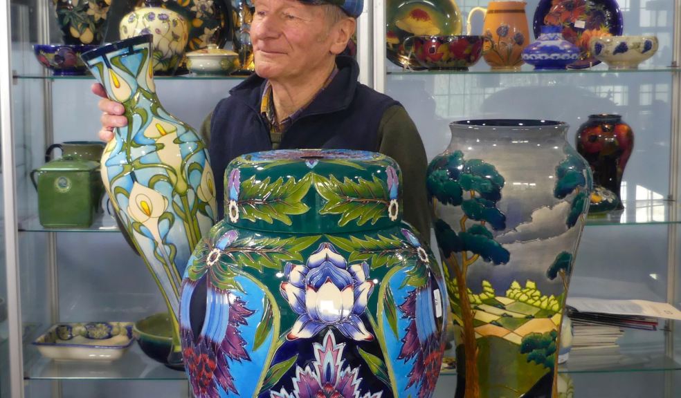 Auctioneer with examples of Moorcroft Pottery