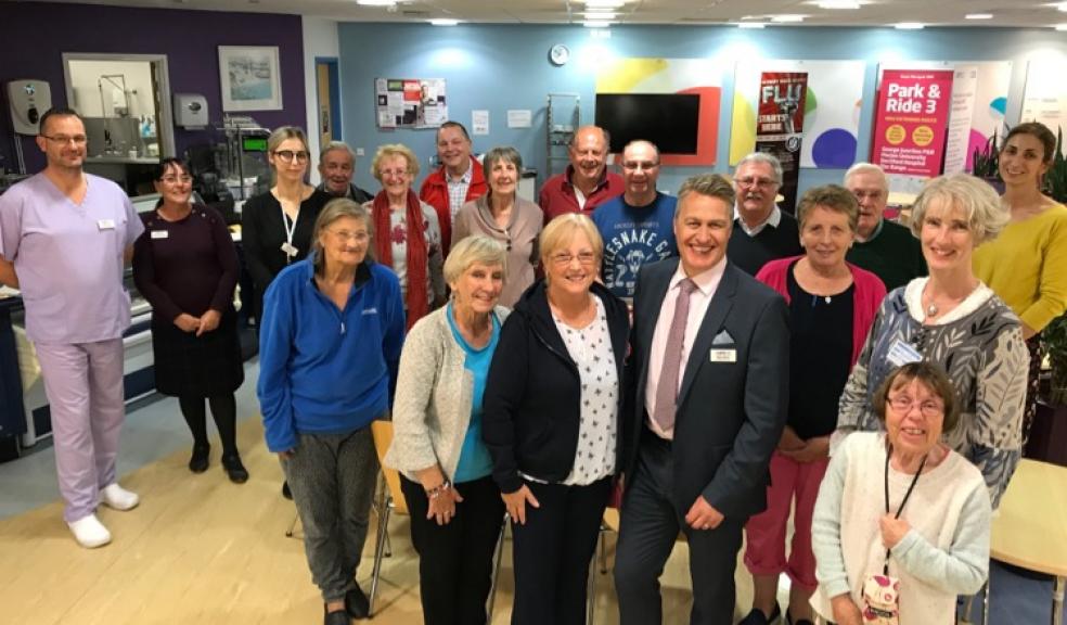 Mark White, Hospital Director at Peninsula NHS Treatment Centre (centre) flanked by Wendy Wilson, Founder and Chair of Plymouth and District Bowel Cancer Support Group (to his left) and Dr Selina Goodman, Genetic Counsellor from the University of Plymouth (to his right) with members of the Plymouth and District Bowel Cancer Support Group