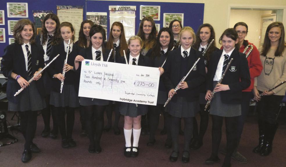 Members of Ivybridge Community College's Flute Ensemble with the cheque for £275 that they raised for St Luke's Hospice.