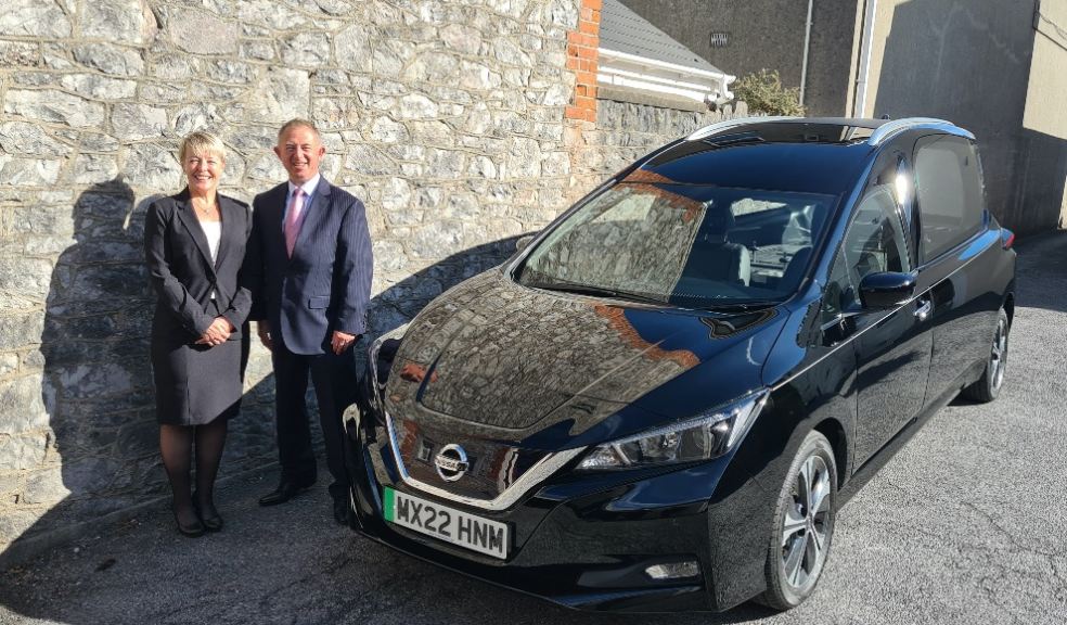 Funeral Partners Area Development Manager Sandra Murphy with Malcolm Brooks from Wilcox Limousines Devon’s first electric hearse to give loved ones a greener funeral choice