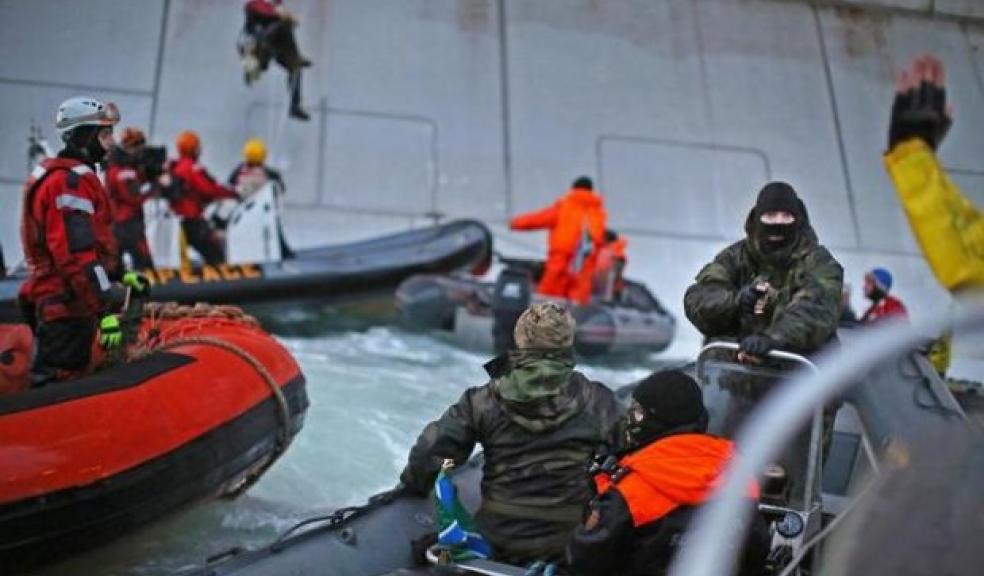 Balaclava wearing men make arrest at gunpoint. Picture courtesy of Greenpeace