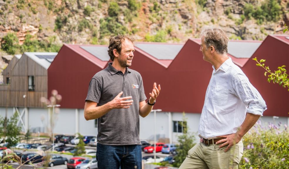 Two people discussing renewable energy at a site installation