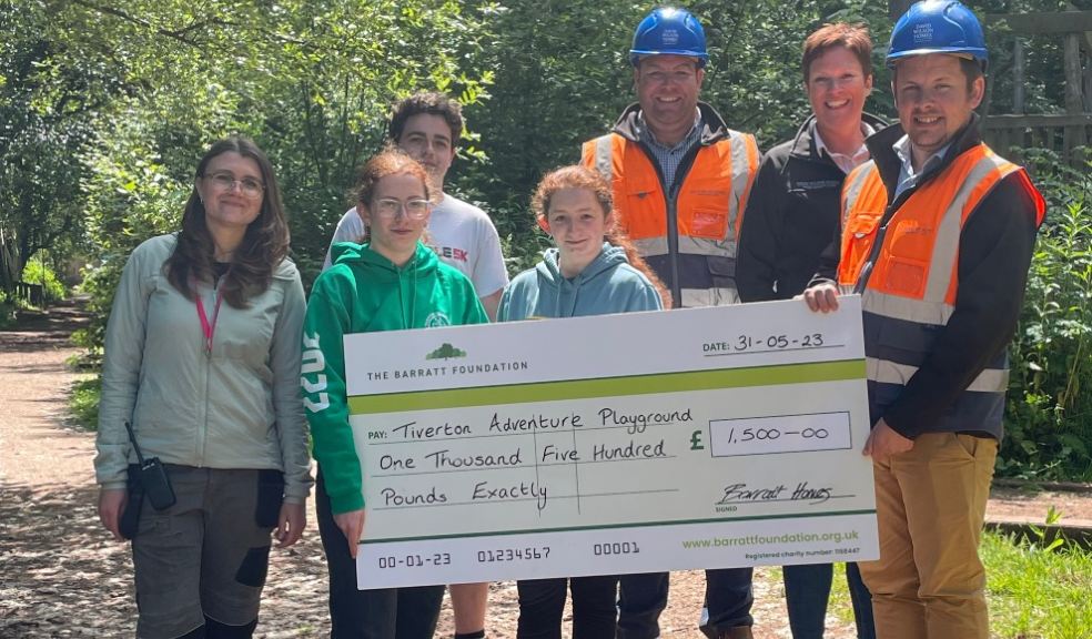 Barratt David Wilson Homes Exeter staff Chris Hickey, Nicki Reid and Henry Tucker presenting a cheque to Ash Taylor, Committee Chair of Tiverton Adventure Playground and children.