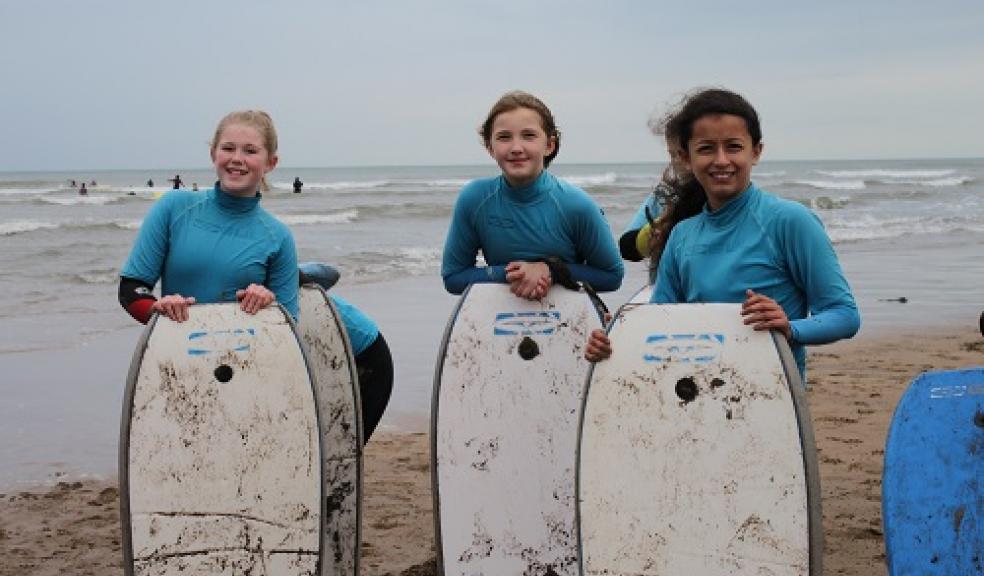 Ready to hit the surf are from left to right Grace Tregidgo, Mai Visick, and Mia Wilkinson-Flores.