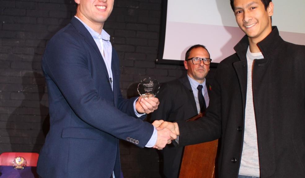 Caliph Ali receiving his progress award from Dean Squires.