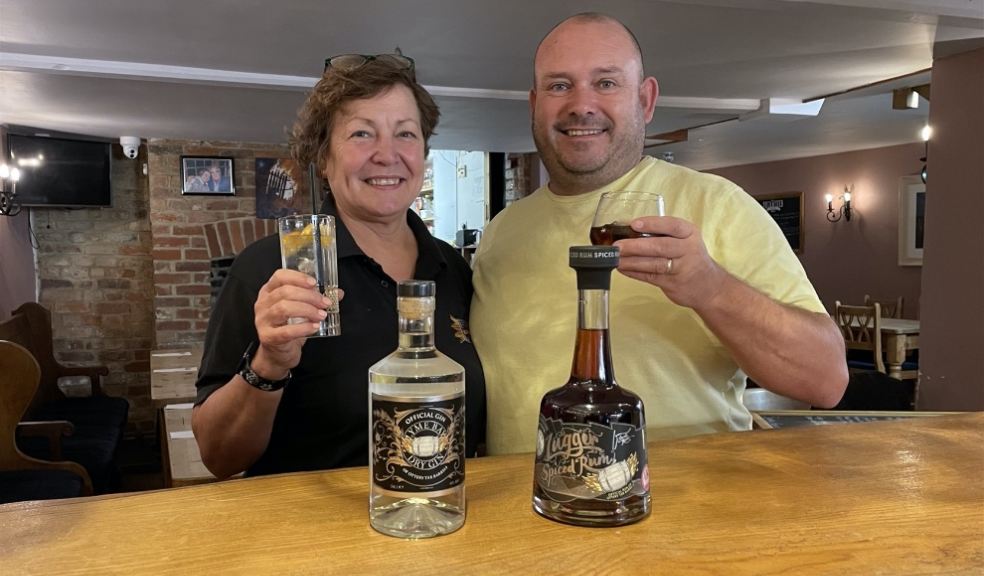 Jacqui and Mike Down tasting the spirits man and woman tasting a bottle of gin