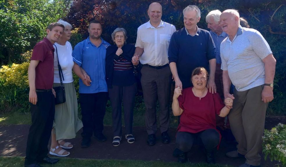 James Marchant (centre) with residents and staff of Camelot Care