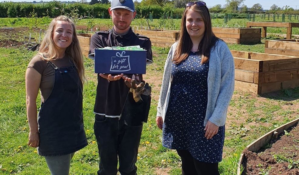 Handing over the box of seeds