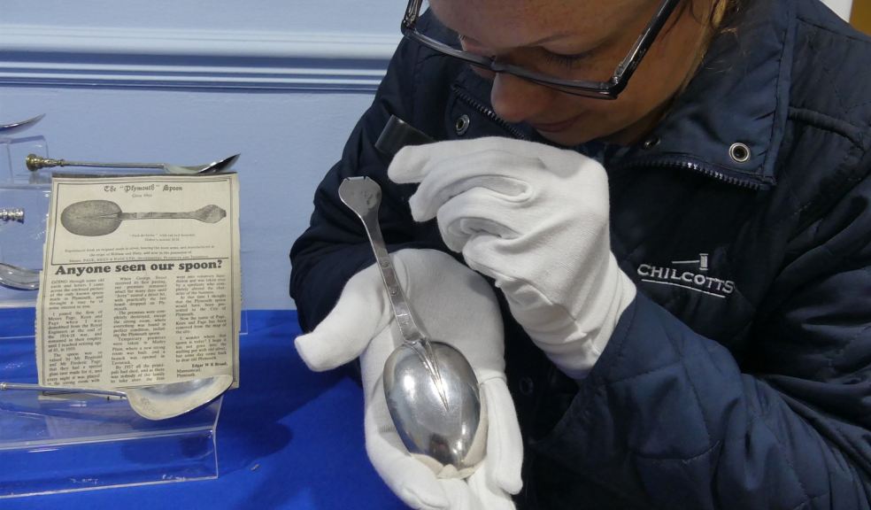 Jennifer Bell from Chilcotts examining a silver spoon