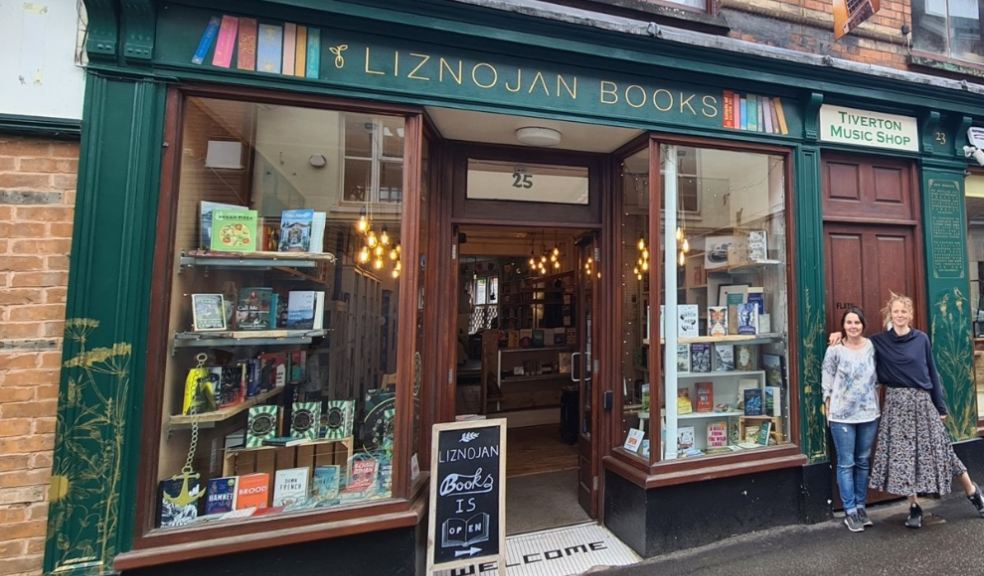 Bookshop with books in the window and two women standing outside