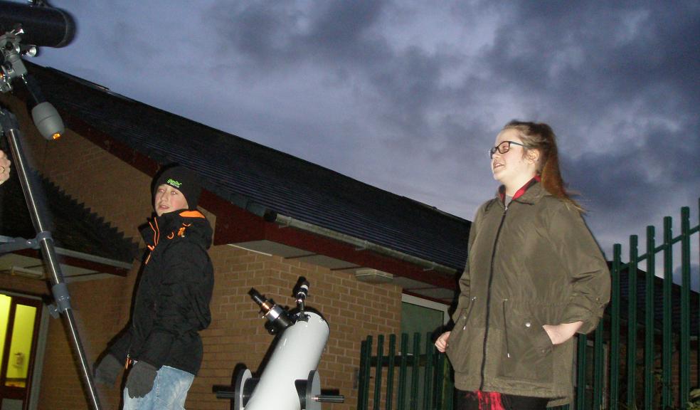 Joran Hobbs and Jasmin Paige Methven looking at the crescent moon