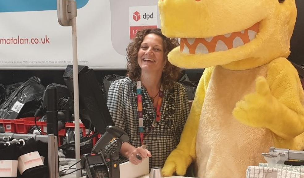 Pantosaurus with Colette Kerton behind the tills at Matalan in Plymouth