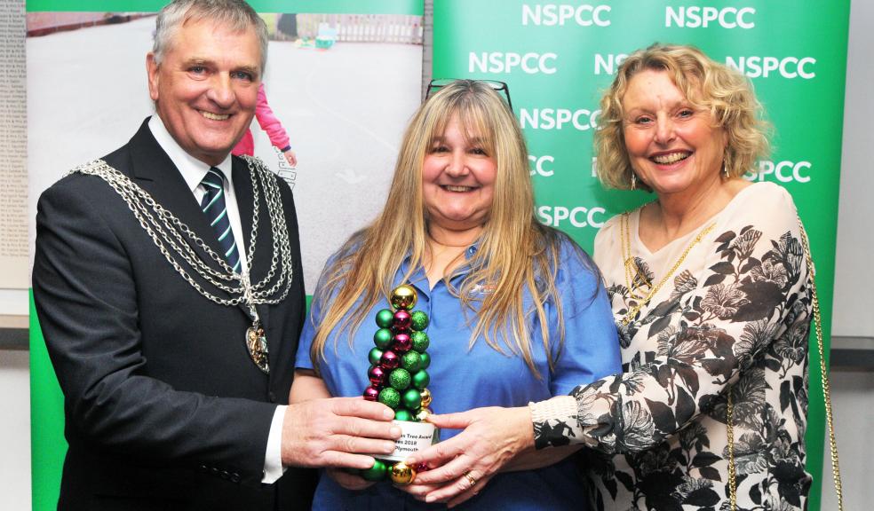 Paula Stebbing from David May Motors is presented with the award for 'Best Decorated Tree' from the Deputy Lord Mayor, and Deputy Lady Mayoress of Plymouth. Credit Nic Randall