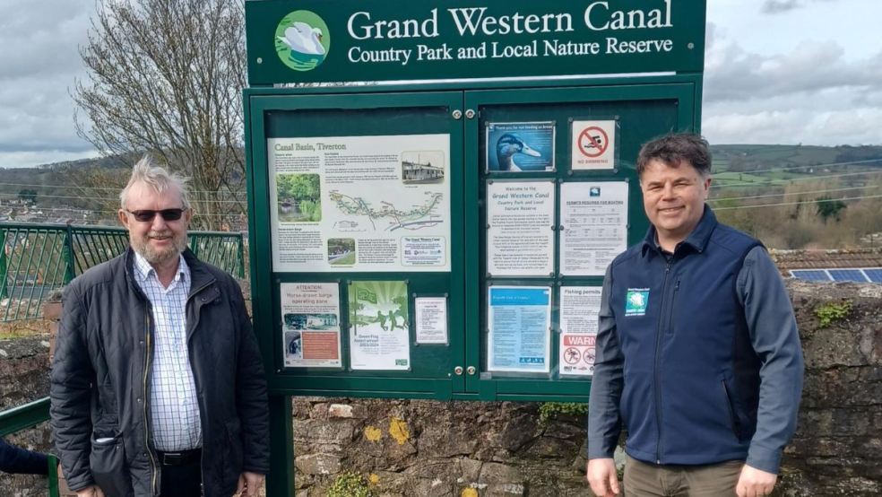 Ray Alexander (IWA) and Mark Baker (Grand Western Canal Country Park Manager) beside one of the new noticeboards.