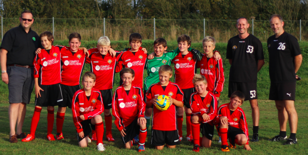 Picture shows: Nathan Hopper (left) with Saltash United Under 12s team and Adam Griffiths (team coach) and Steve Buckler (team manager) far right.