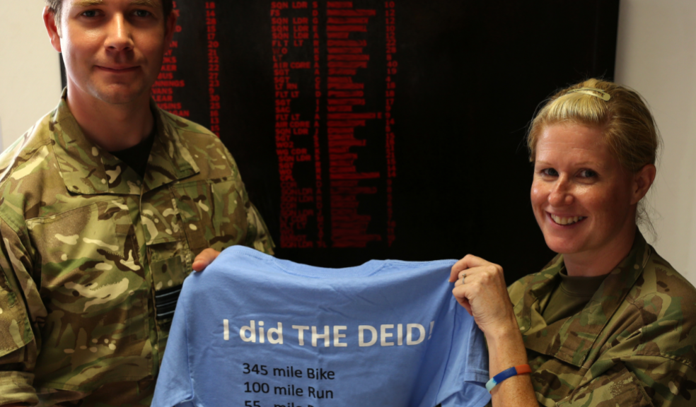 Squadron Leader Tracey receiving her challenge t-shirt from Squadron Leader Jim, Officer Commanding the Air Base Challenge.