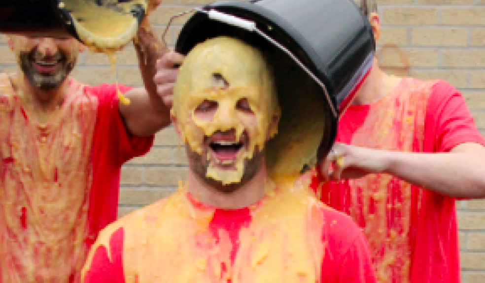 Andy Price, Director of Sport, who was voted in first place, getting covered in cold custard.