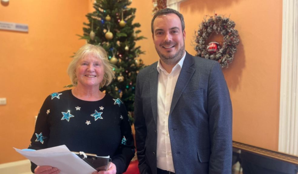 Simon Jupp MP and Carolyn Burton with petition signatures.