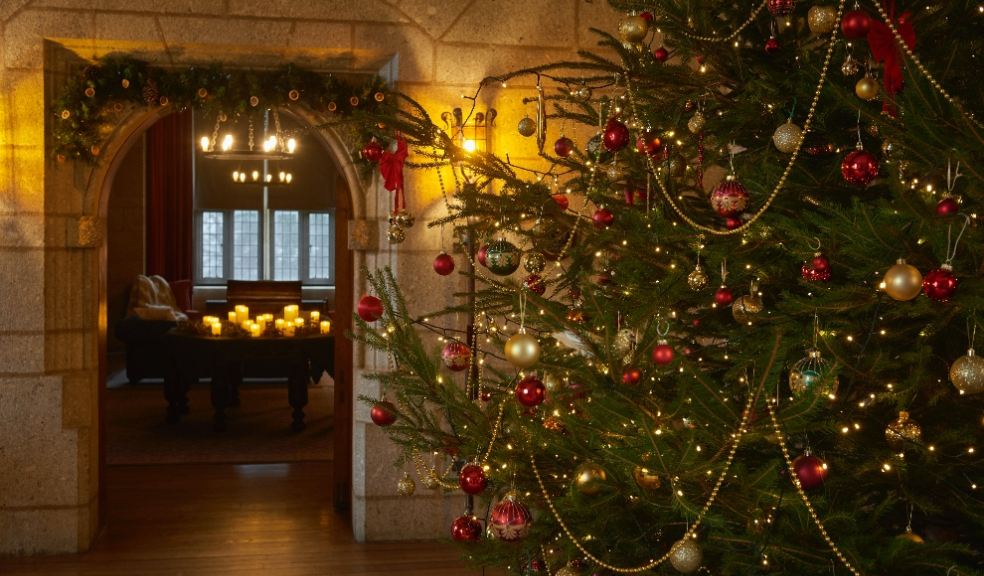 Entrance hall decorated for Christmas at Castle Drogo in Devon