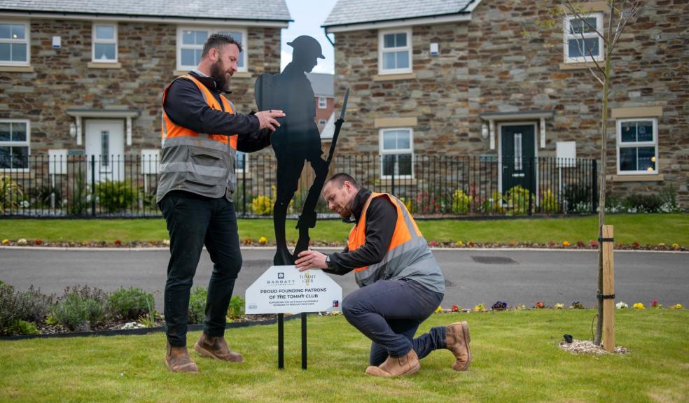 site managers installing Tommy figure at Braid Park, Tiverton