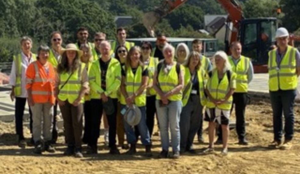 Work begins on new community-led affordable housing in Dartington Building team stood on land in hi vis jackets