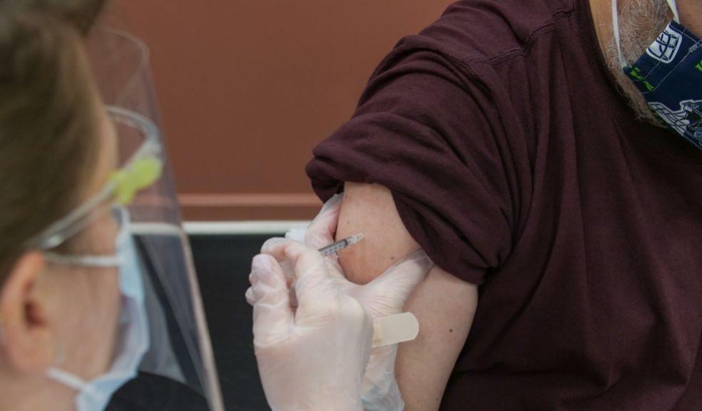 An image showing a person receiving a vaccination jab in the arm