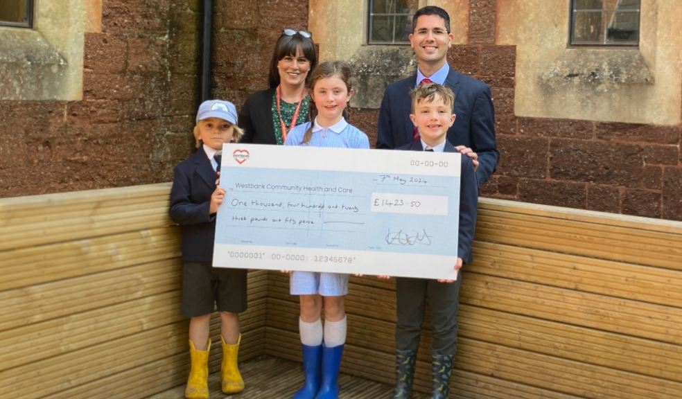 Westbank's Head of Fundraising and Marketing receives a large donation from the headteacher and pupils at Exeter Pre-Prep School.