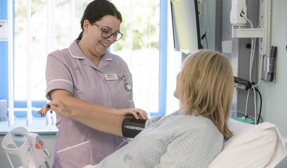 Peninsula NHS Treatment Centre Health Care Assistant Leah Coombes tends to a patient. The hospital has scored top marks from patients for the quality of its care.