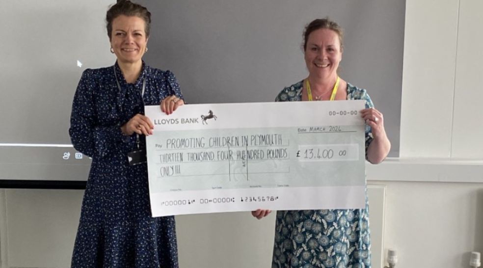 Womble Bond Dickinson's Nikki Jonas presents a cheque to Kerry Bidewell from Plymouth Children in Poverty