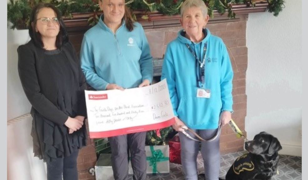 Maria Nolan and Sophie Page present the fundraising cheque to Guide Dogs volunteer Di Hatchett and g