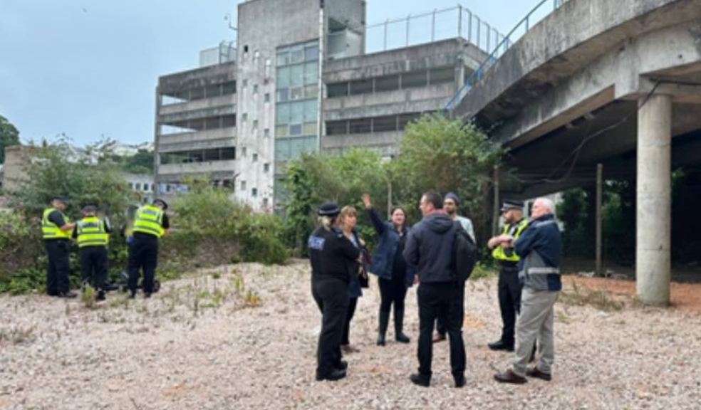 Photo caption: Photo of the meeting taking place outside and the arrests that were made during the meeting.