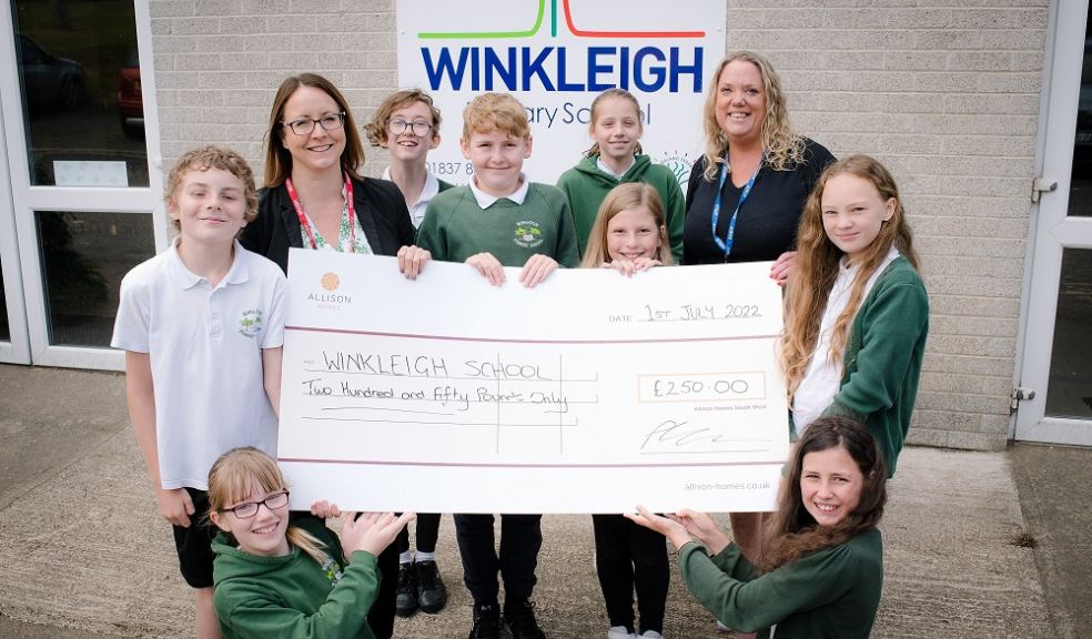 Michele Jones, Allison Homes Sales and Marketing Manager, presents a cheque for £250 to Executive Headteacher, Mrs Victoria Fenemore and Year 6 pupils at Winkleigh Primary School.