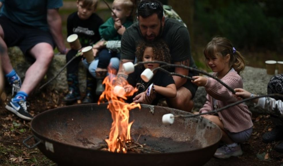 Children roasting marshmallows on a camp fire