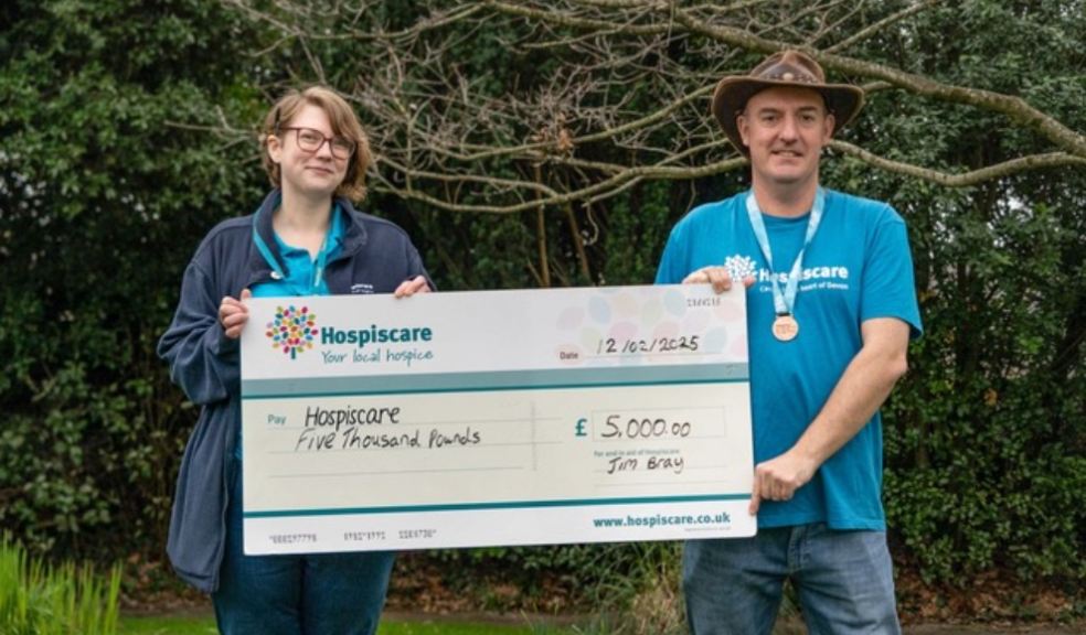 Photo caption: Jim Bray (right), wearing the Hospiscare Hero medal he was presented with, hands over a cheque for £5,000 to Alice Pragnell, the charity’s corporate and events co-ordinator.