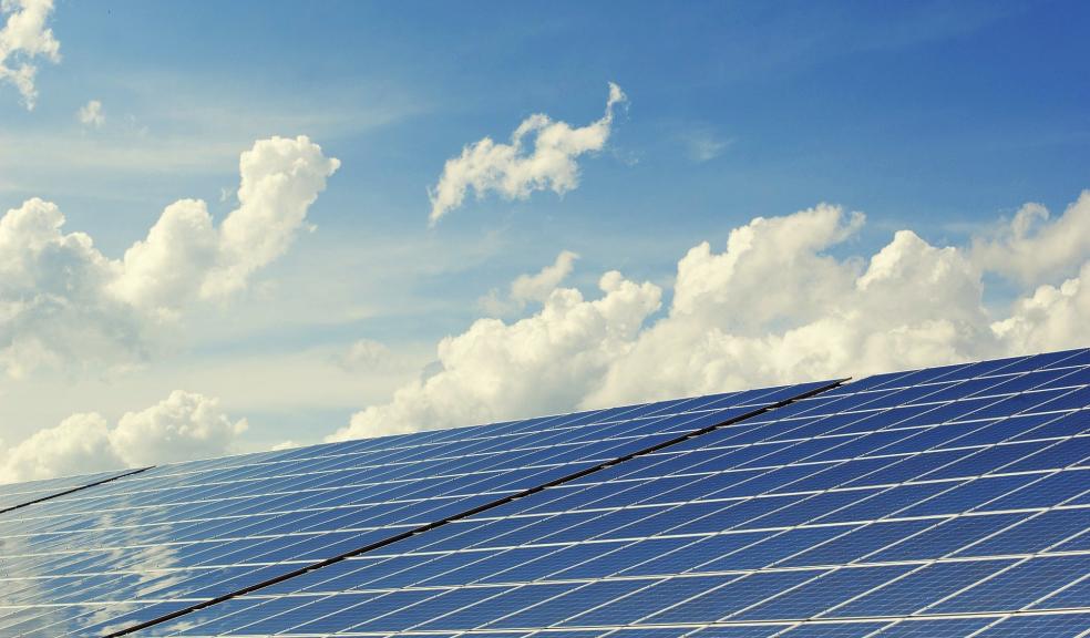 A bank of solar panels against the sky