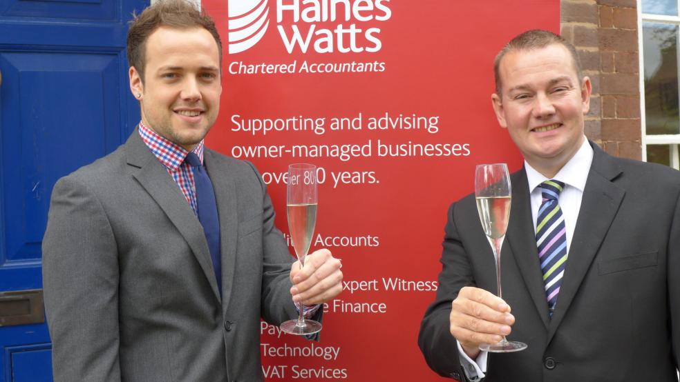 Ryan Lewis toasts his examination success with Patrick Tigwell, Partner Haines Watts Exeter.