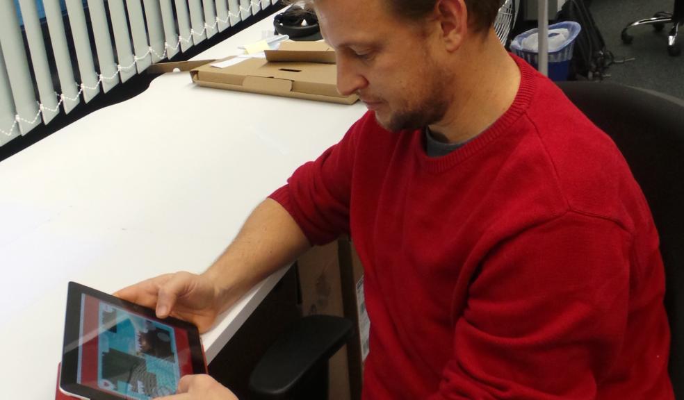 Elf Help: Sponge UK Games Developer, Jason Butler tests out the game on a tablet.
